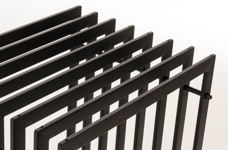 Sort metal magasinholder med rum Detalje af sort metal magasinholder med flere rum