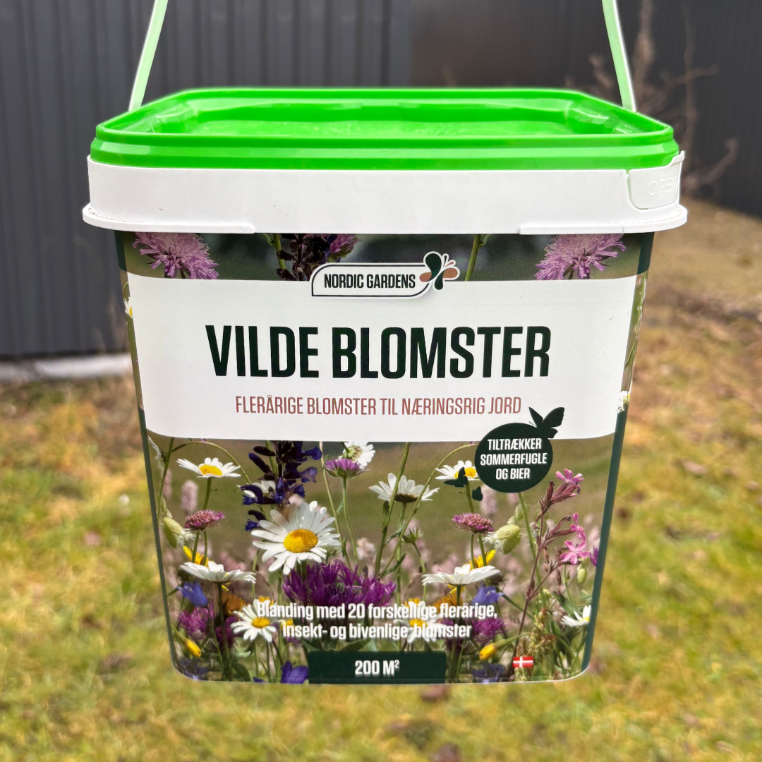 Nordic Gardens Blomsterblanding Vilde Blomster - 200 m² | 20 flerårige blomster, tiltrækker bier og sommerfugle Billede af emballage til Nordic Gardens Blomsterblanding 'Vilde Blomster' til 200 m², plastspand med grøn låg og motiv af vilde blomster. Indeholder 20 forskellige flerårige blomster, godt for bier, sommerfugle og insekter.