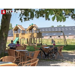 Hy-Land legeplads i træ med gynger og rutsjebane Udendørs Hy-Land trælegeplads ved café med gynger og rutsjeb