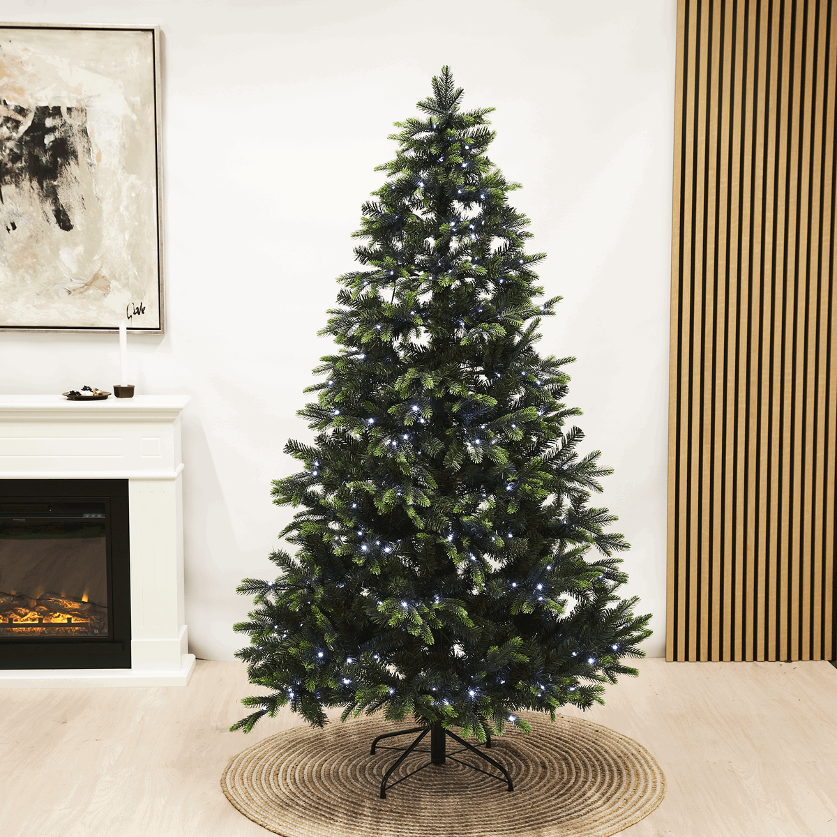 Kunstigt juletræ med LED-lys på metalfod Grønt kunstigt juletræ med hvide LED-lys indendørs