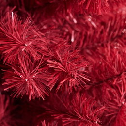 Rød kunstigt juletræ med nåle Nærbillede af rødt kunstigt juletræ