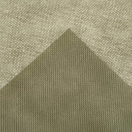 Beige tekstureret stof med små prikker Nærbillede af beige mønstret tekstil med struktur