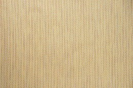 Beige vævet tekstil med struktur Nærbillede af beige vævet stof med fin struktur