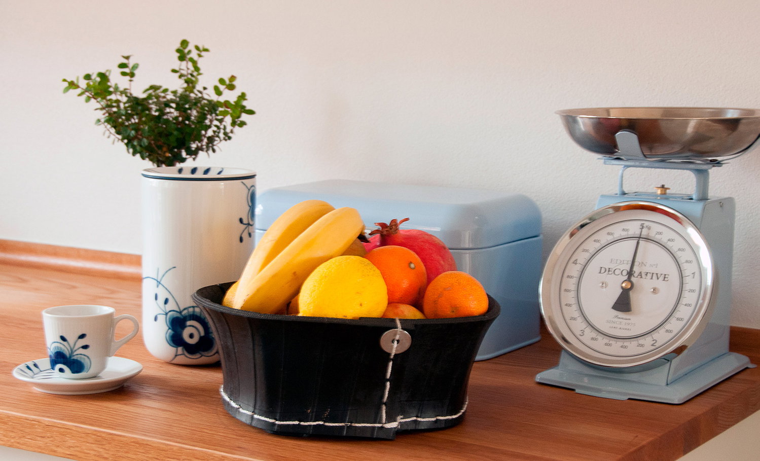 Retro køkkenvægt med frugtkurv Retro køkkenvægt, frugtkurv og porcelæn på bord