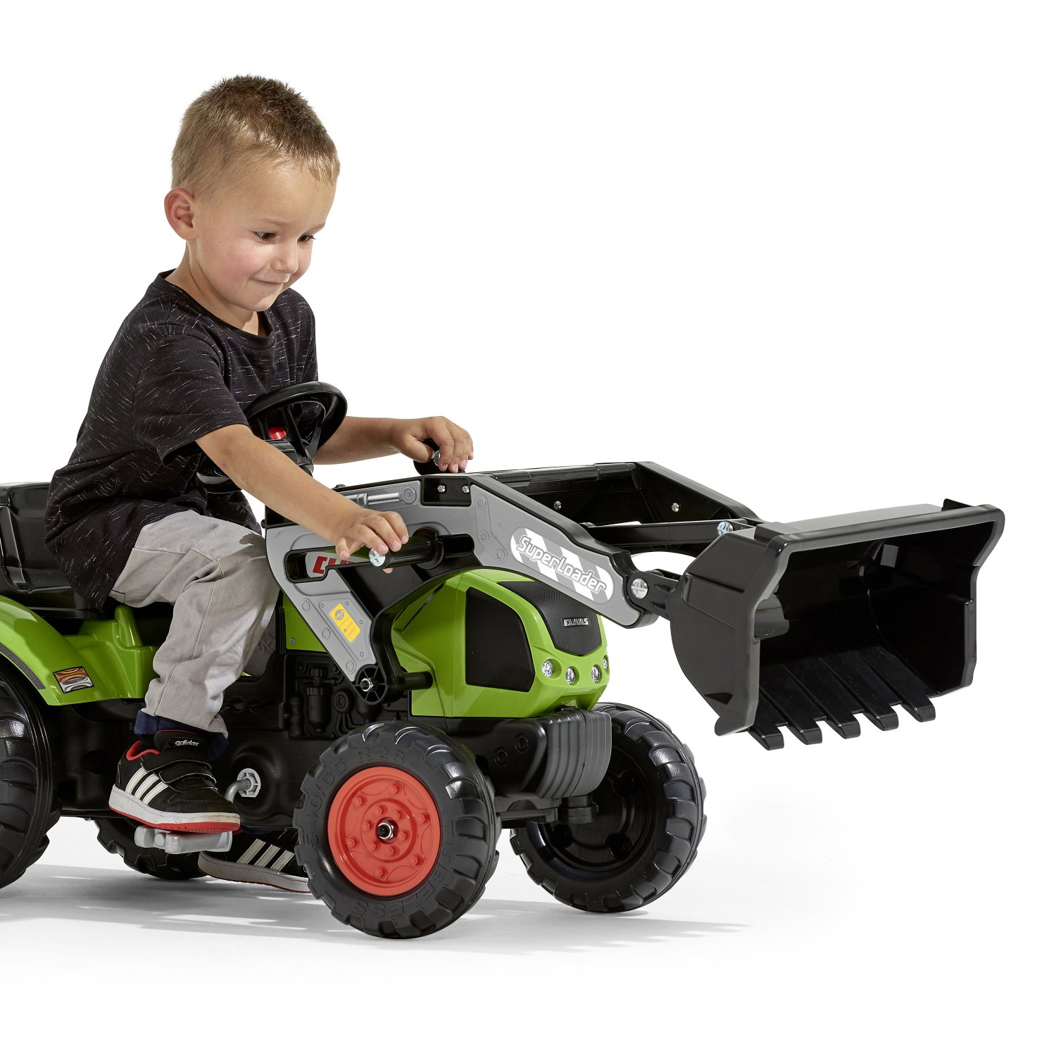 Børnetraktor med frontlæsser, pedaltraktor grøn Dreng kører på grøn pedaltraktor med frontlæsser