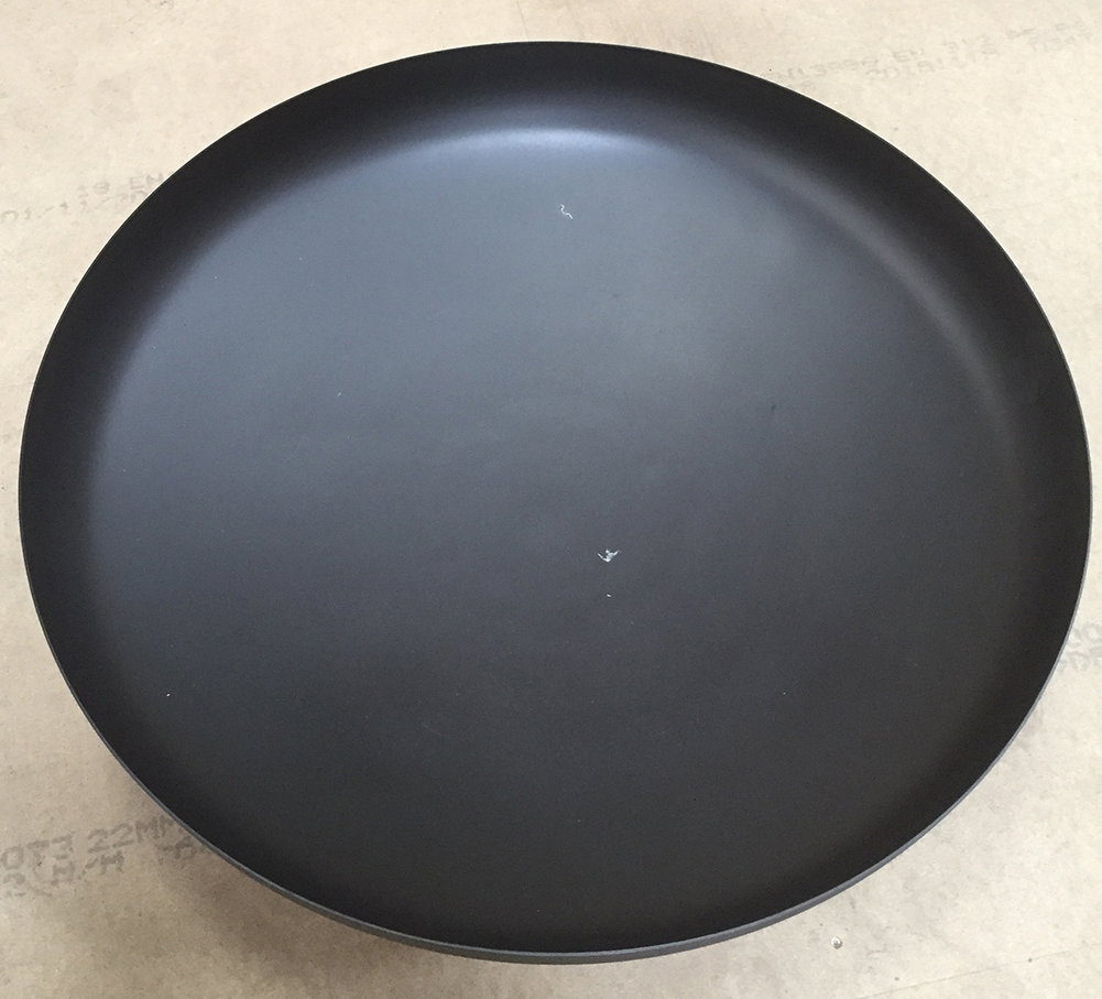 Rund sort middagstallerken i minimalistisk design Sort rund tallerken med mat overflade på bord