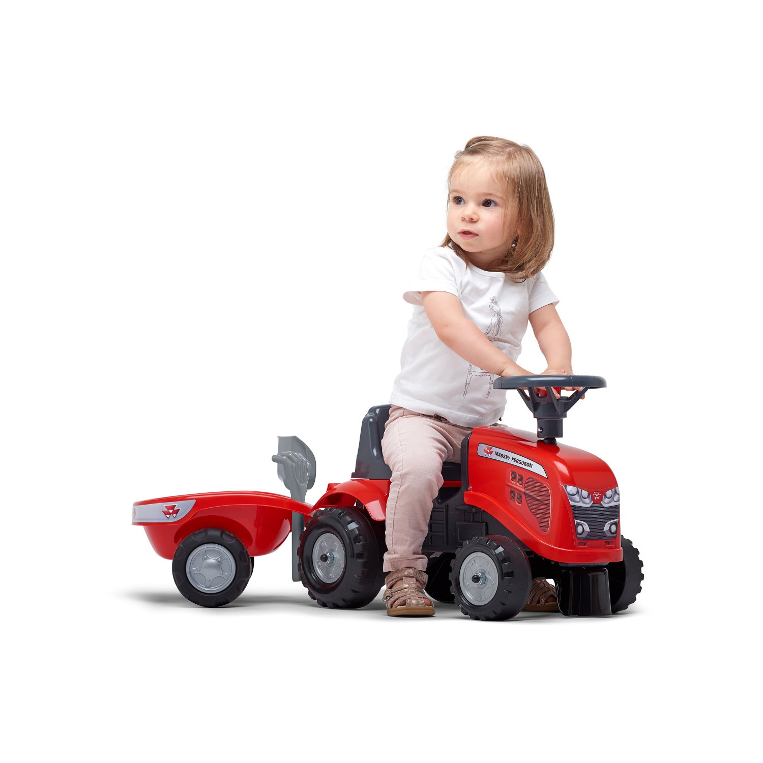 Rød legetraktor med trailer til små børn Barn kører på rød legetraktor med trailer