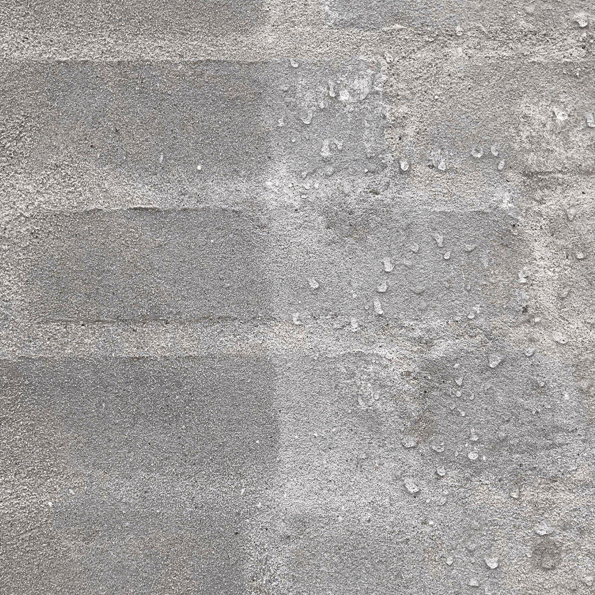 Nærbillede af grå ru betonvæg