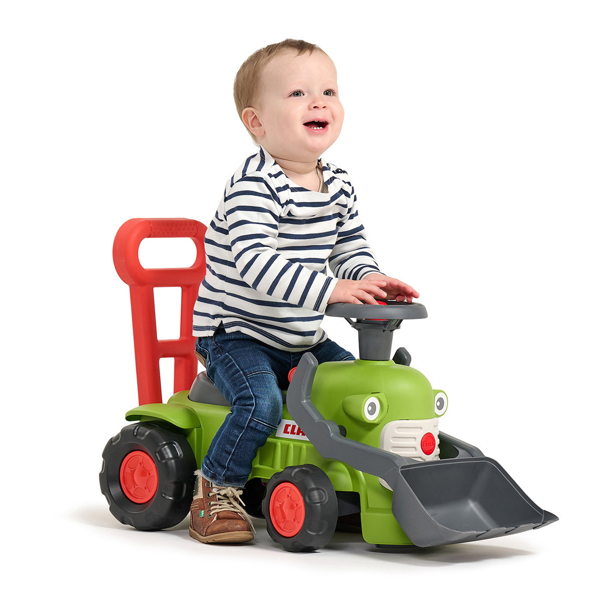 Traktor med rat, horn og skubbehåndtag Claas Vintage – FALK babylegetraktor til 1-3 år Barn sidder på grøn Claas Vintage babylegetraktor med rat, horn, frontskovl og rødt skubbehåndtag – FALK legetøj, ideel som gangstøtte og til motorisk leg for 1-3-årige