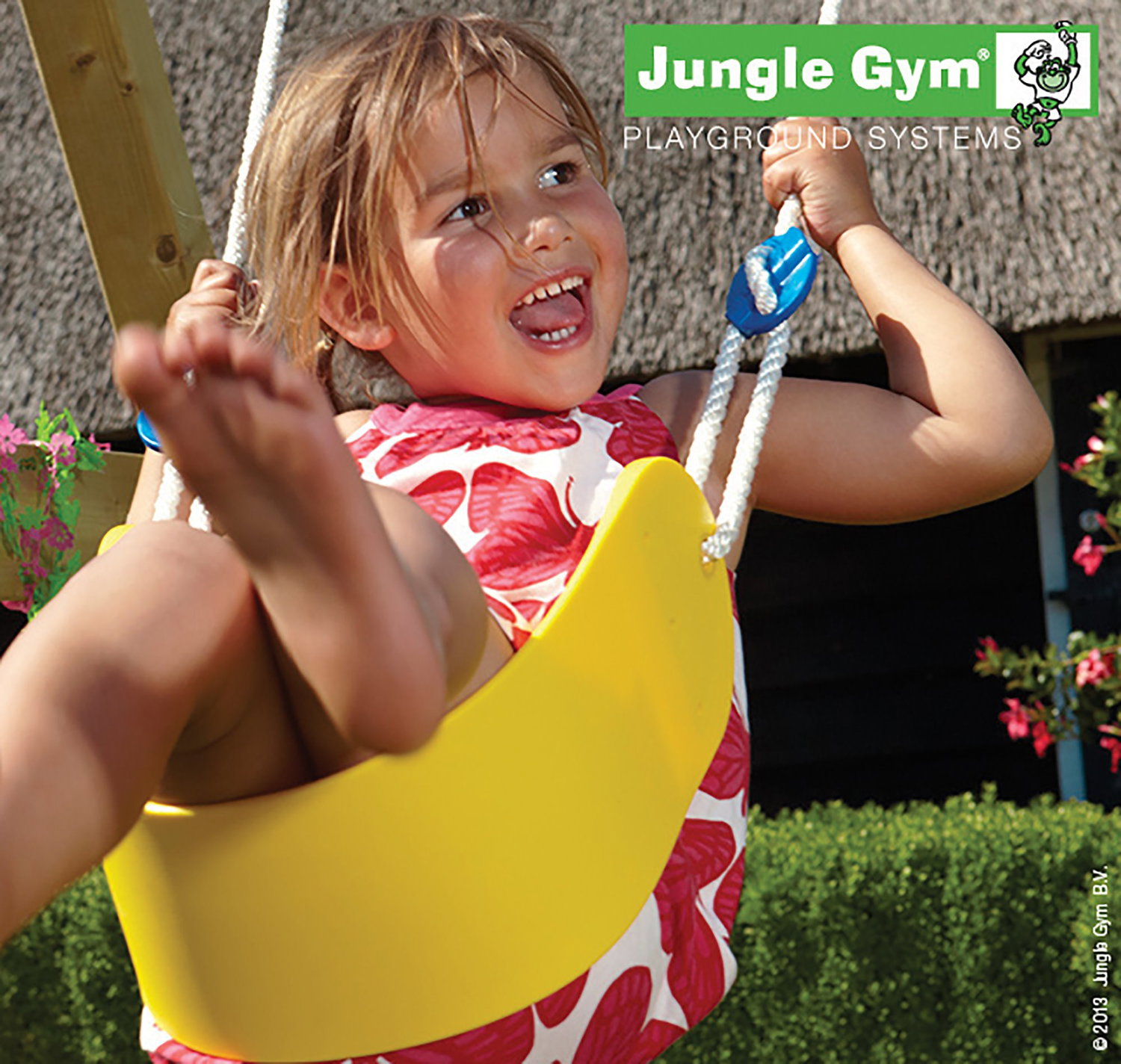 Jungle Gym gynge til glade børn i haven Barn gynger på gul Jungle Gym gynge i haven