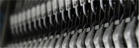 Nærbillede af metalclips i række med fokus på tekstur og gentaget mønster Nærbillede af række metalclips eller -dele i gråtoner, detaljeret tekstur og gentaget industrielt mønster
