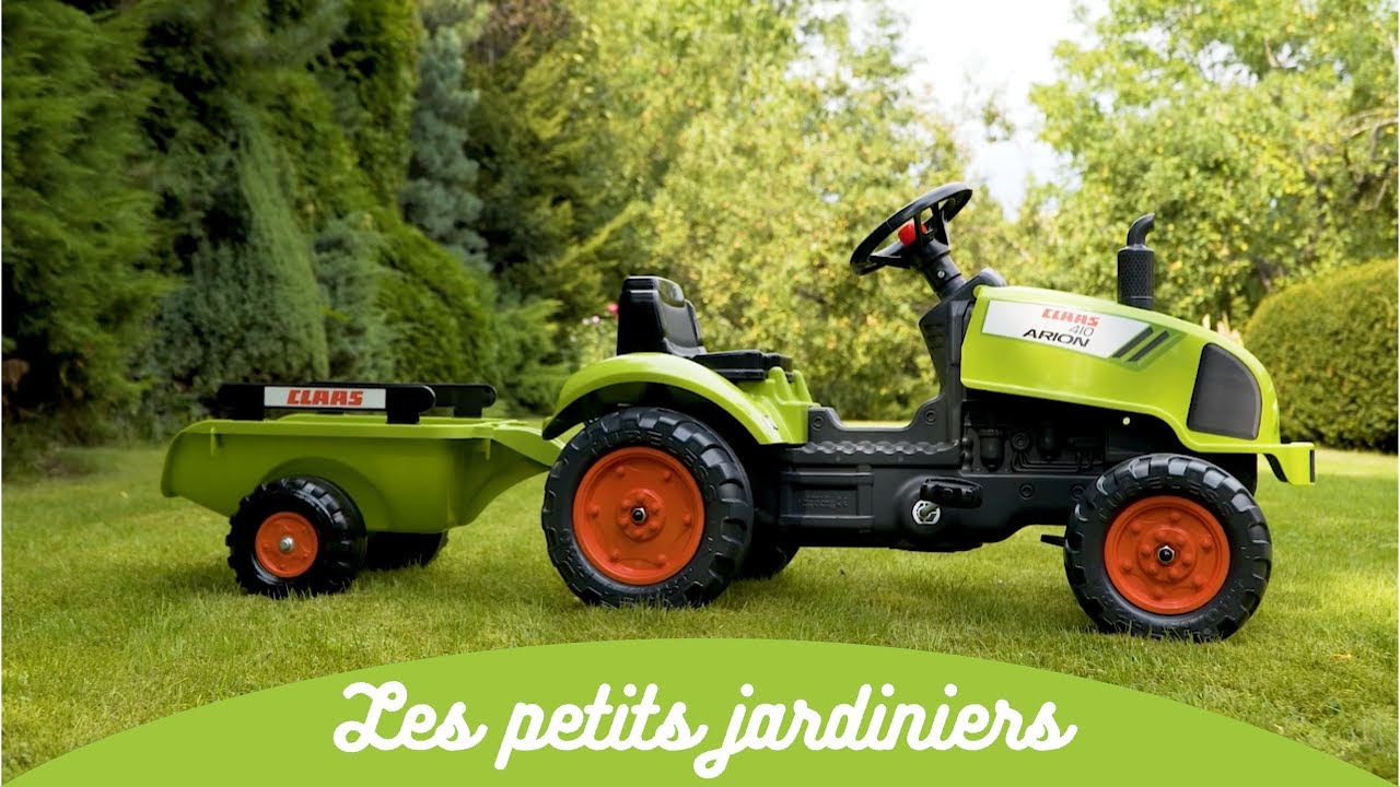 Claas pedaltraktor inkl. vogn – FALK Claas Arion 410 pedaltraktor til 2–5 år, robust og lavet i Frankrig Claas pedaltraktor med vogn (Arion 410) i grøn og orange fra FALK, børnetraktor til 2–5 år med åbnet motorhjelm, rat og horn, robust trailer til sand, blade og leg i haven